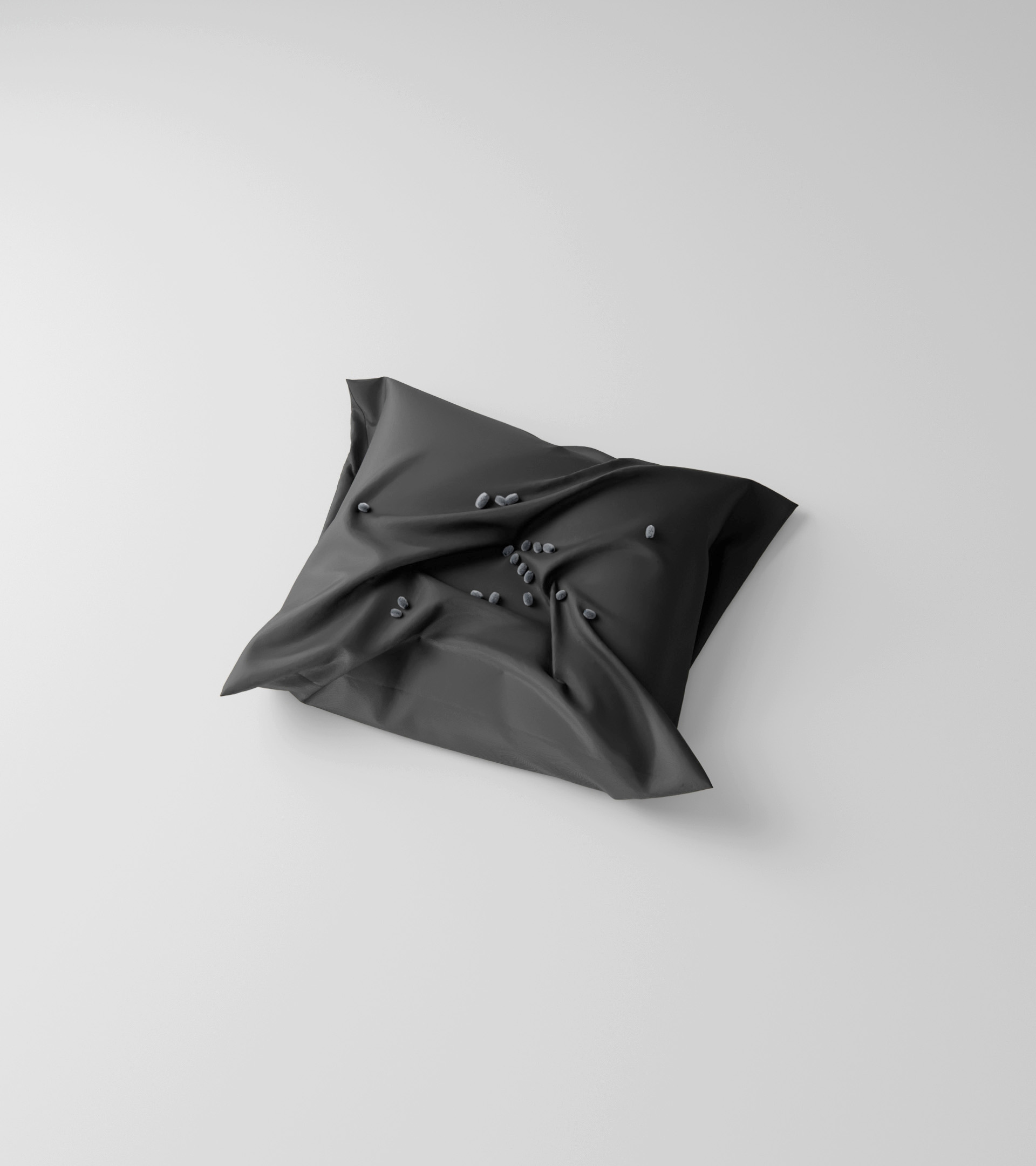 3D render: a folded black cushion on white